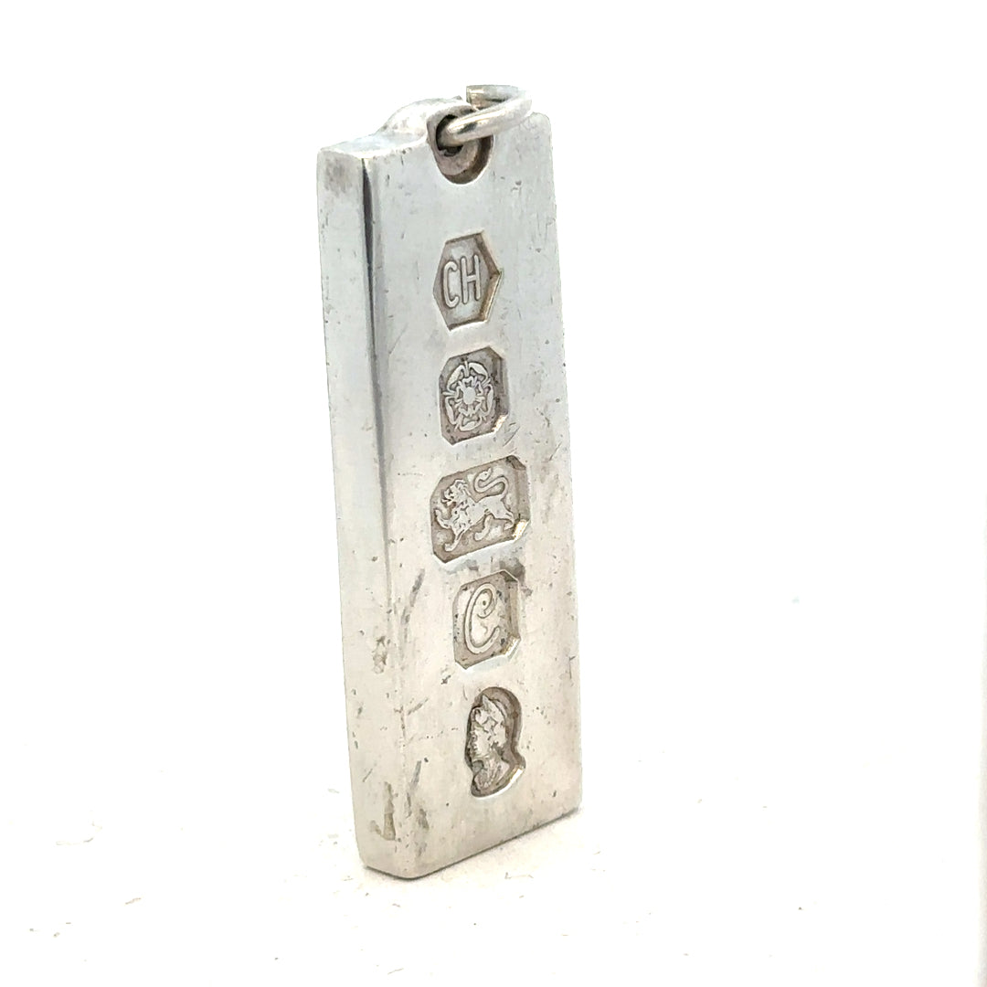 Silver ingot pendant, 31g, unbranded, with a sleek rectangular design and polished finish, hanging on a chain.