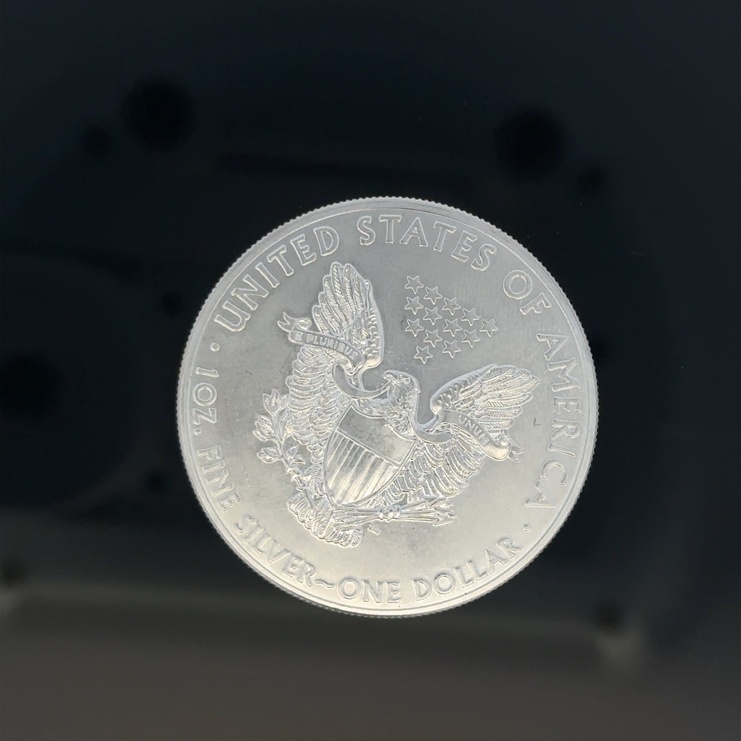 Silver one dollar coin, 31.2g, unbranded, with detailed engravings visible on the surface of this collectible silver coin.