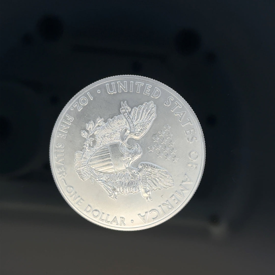 Silver one dollar coin, 31.2g, unbranded silver coin with detailed engravings and classic design.