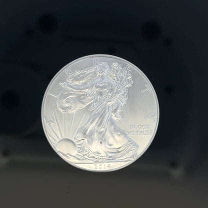 Silver one dollar coin, 31.2g, unbranded silver coin with detailed design on its surface.
