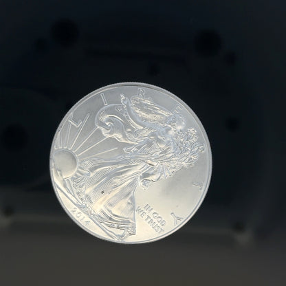 Silver one dollar coin weighing 31.2g, unbranded silver coin with detailed design visible in the image.