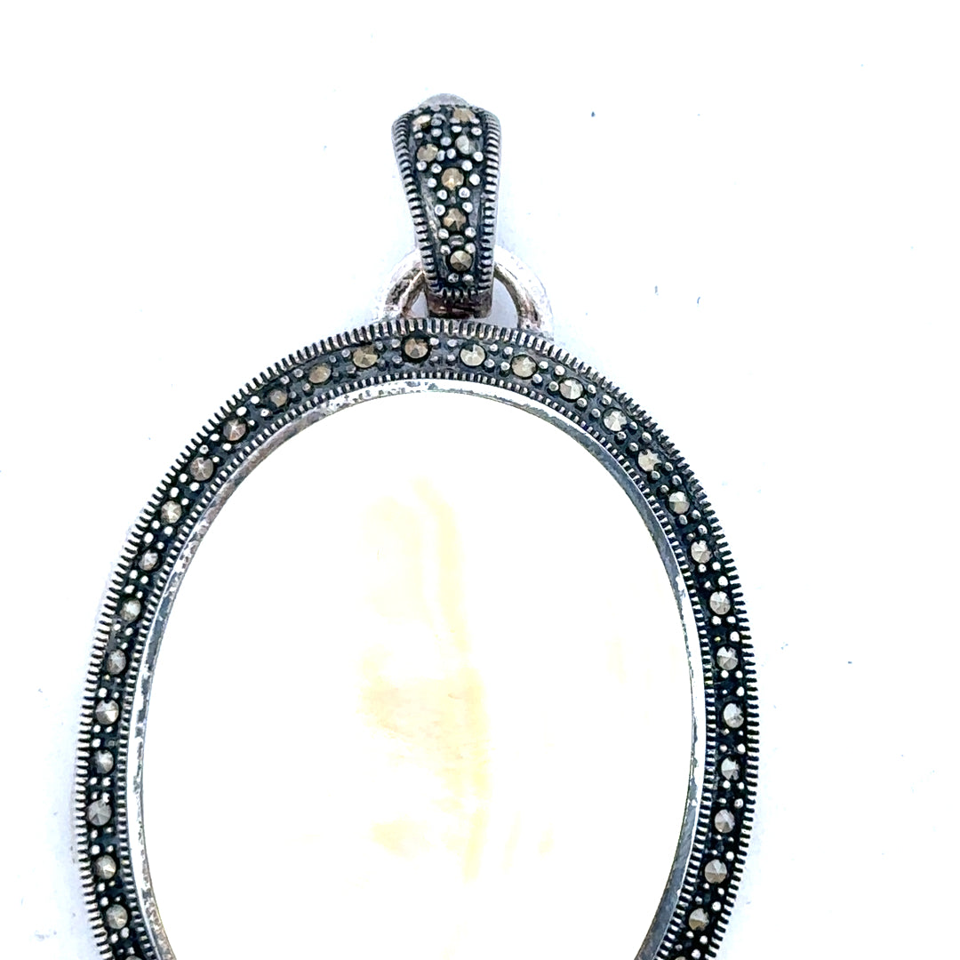 Silver pendant weighing 32.5g, unbranded, shown with detailed close-up of its polished surface and pendant shape.