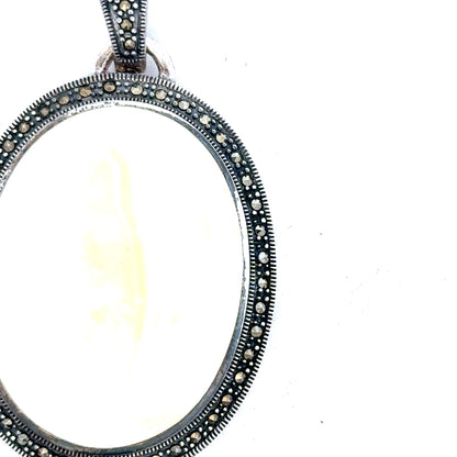 Silver pendant weighing 32.5g, unbranded, with a sleek, polished design, showcased on a plain background.