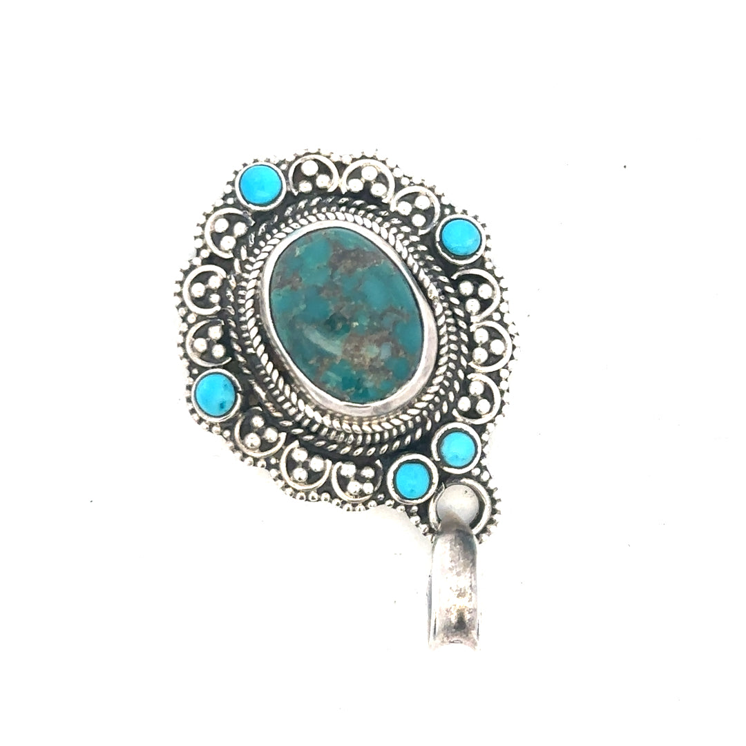 Silver pendant weighing 15.9g with intricate design, displayed on a neutral background, unbranded jewelry accessory.