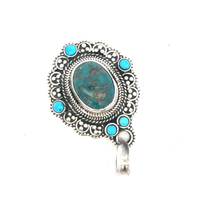 Silver pendant weighing 15.9g with intricate design, displayed on a neutral background, unbranded jewelry accessory.
