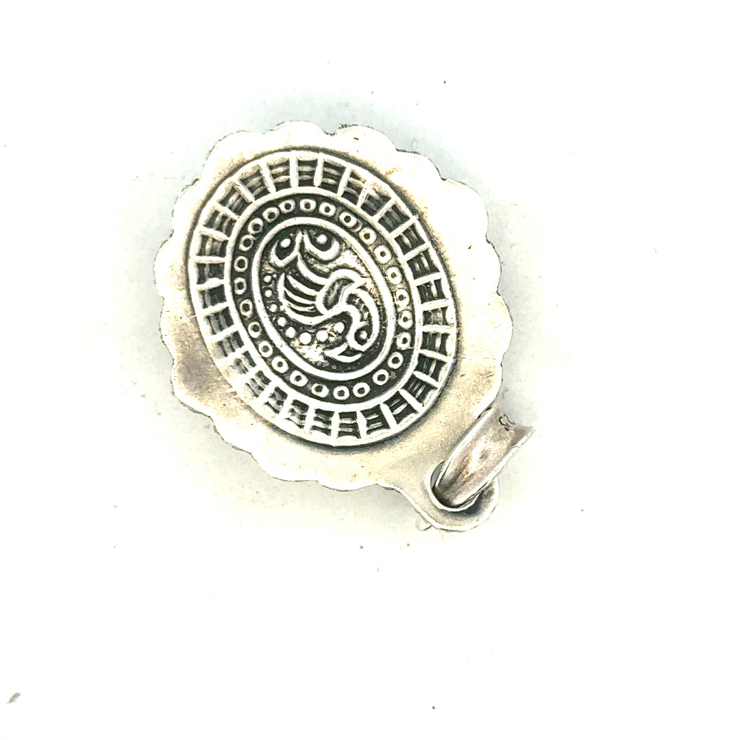 Silver pendant weighing 15.9g, unbranded jewelry accessory with intricate design, displayed against a neutral background.
