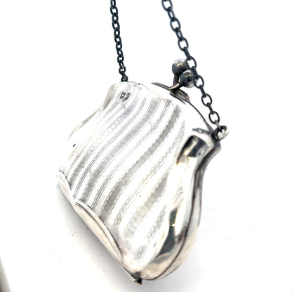 Silver purse pendant weighing 66.2g, unbranded, with intricate details, designed as a jewelry accessory.