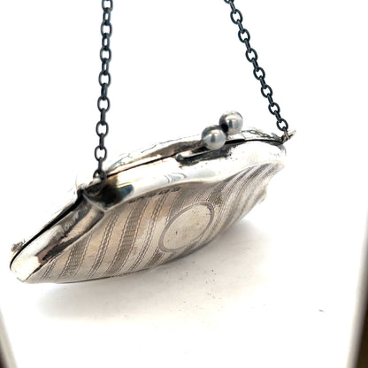 Silver purse pendant weighing 66.2g, unbranded jewelry accessory with detailed design, shown in close-up image.