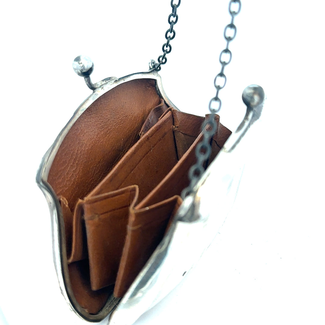 Silver purse pendant weighing 66.2g, unbranded jewelry accessory with detailed design, ideal for necklace or charm collection.