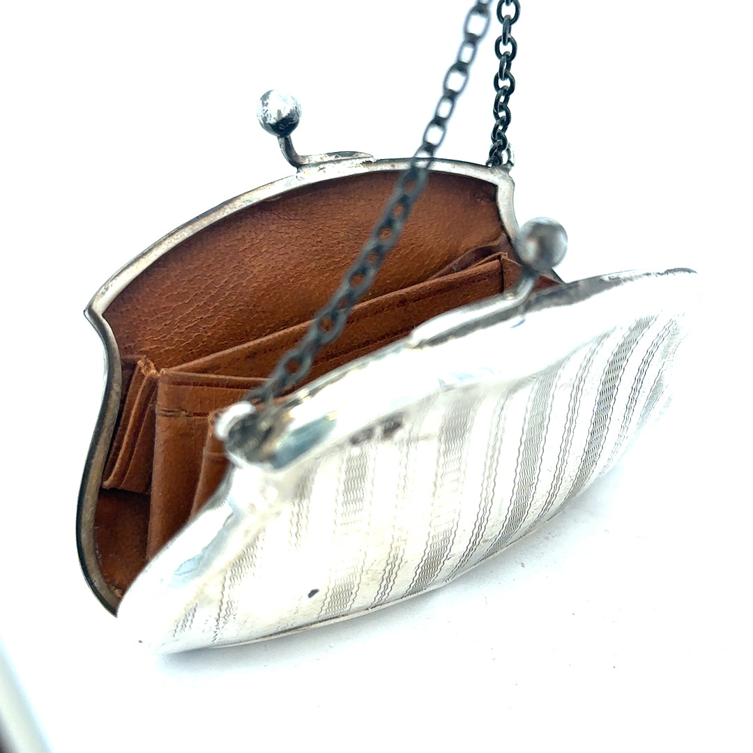 Silver purse pendant weighing 66.2g, unbranded jewelry accessory with detailed design, shown in close-up image.