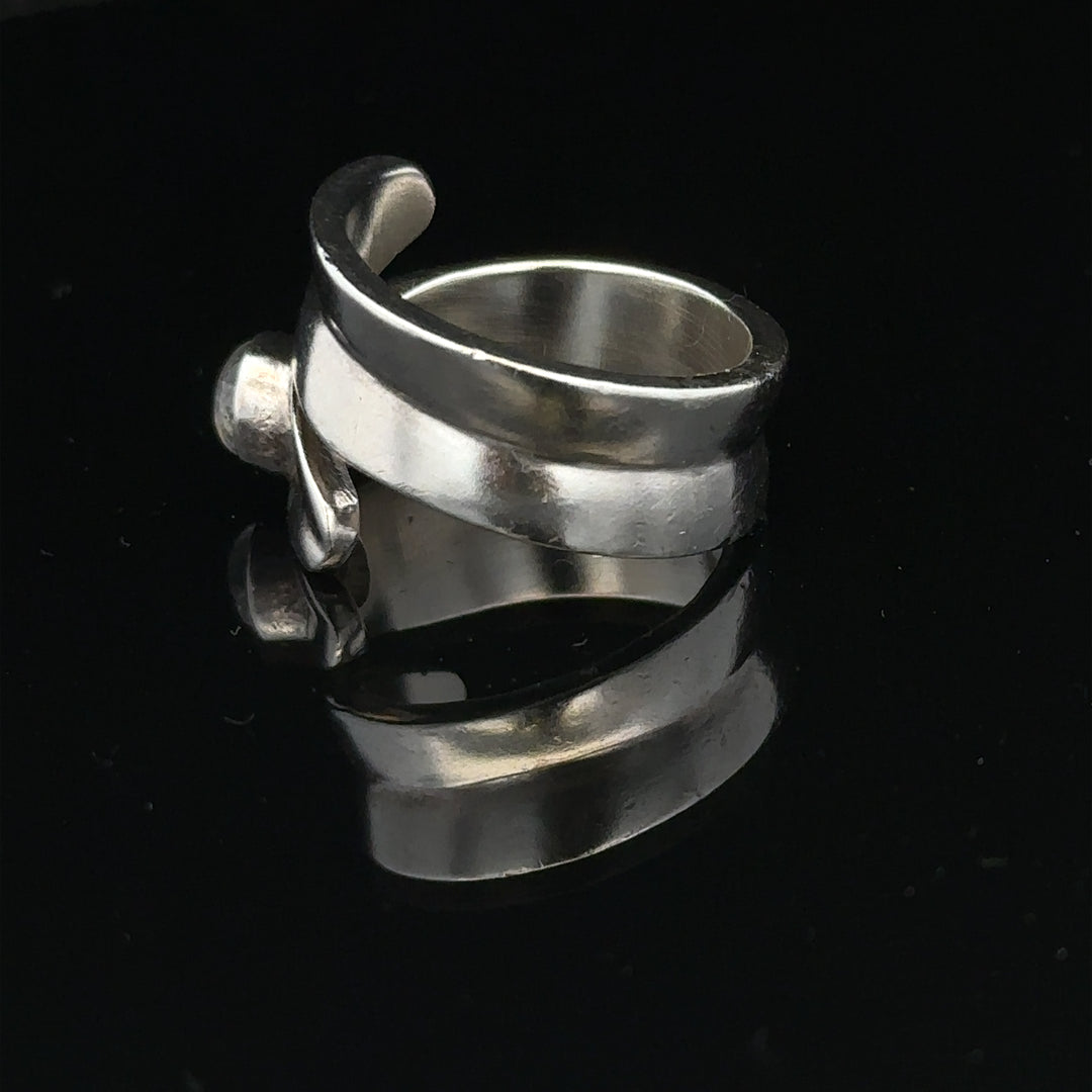 Silver ring size R with a smooth band, unbranded, shown in a close-up image highlighting its sleek design and polished finish.