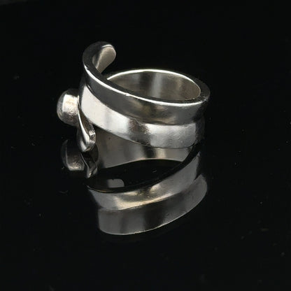 Silver ring size R with a smooth band, unbranded, shown in a close-up image highlighting its sleek design and polished finish.