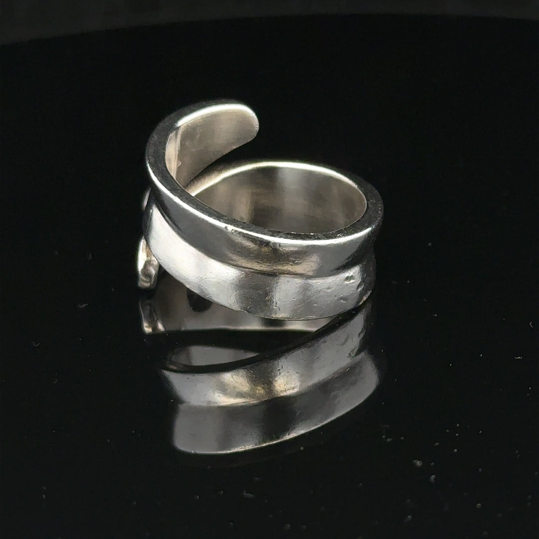 Silver ring size R with a smooth band, unbranded jewelry accessory, shown in a close-up view.