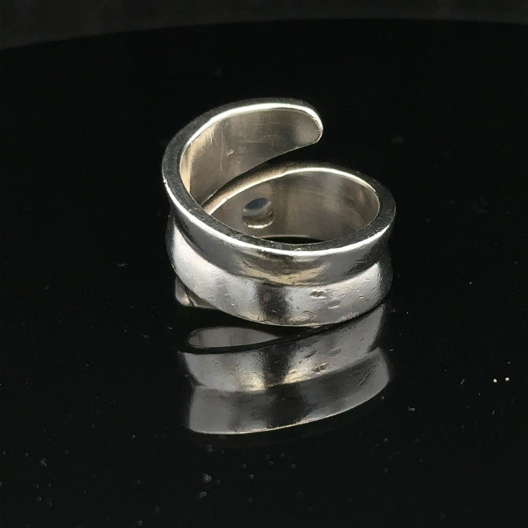 Silver ring in size R with a smooth band, unbranded jewelry piece displayed on a neutral background