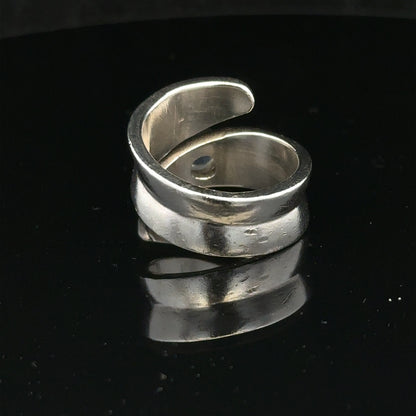 Silver ring in size R with a smooth band, unbranded jewelry piece displayed on a neutral background
