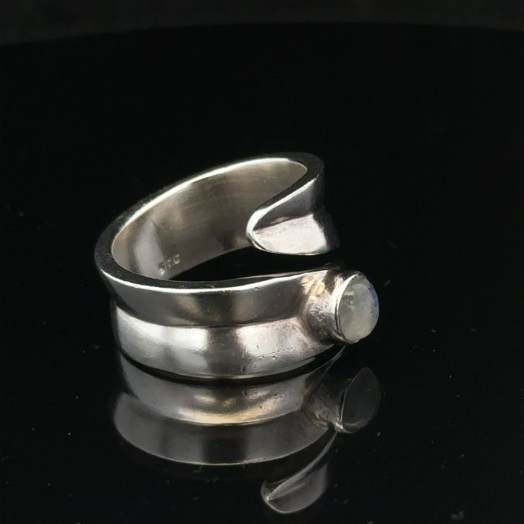 Silver ring in size R with a smooth band, unbranded jewelry piece displayed on a plain background.