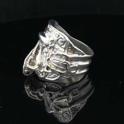 Silver saddle ring in size V with a sleek design, unbranded jewelry piece featuring a smooth, polished finish.