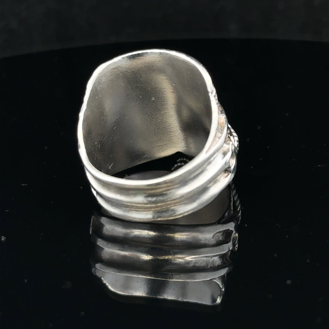 Silver saddle ring size V, unbranded, with a smooth, polished finish, displayed on a neutral background.