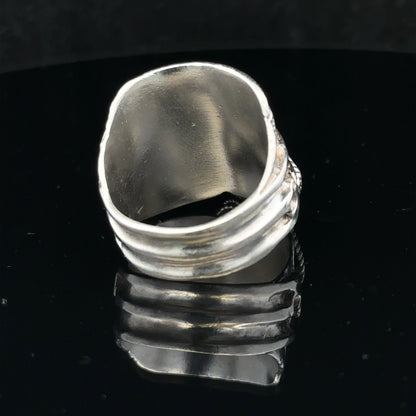 Silver saddle ring size V, unbranded, with a smooth, polished finish, displayed on a neutral background.