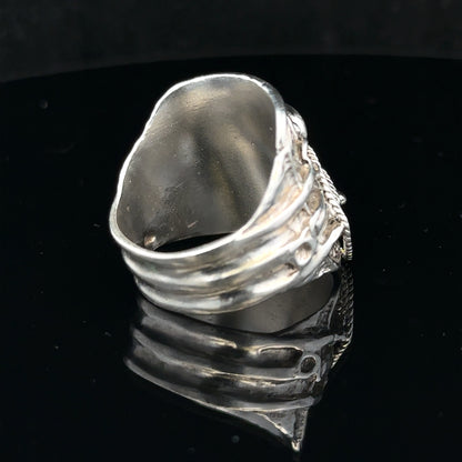 Silver saddle ring in size V, unbranded, showcasing a smooth, polished silver band with a classic saddle design.