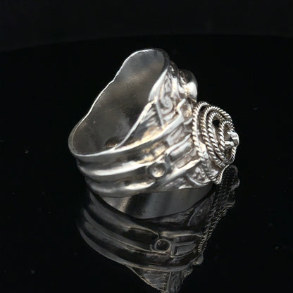 Silver saddle ring, size V, unbranded, featuring a smooth, polished band with a distinctive saddle-shaped design.
