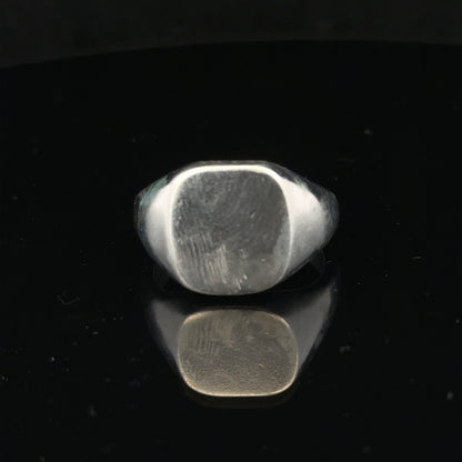 Silver signet ring in size V with a polished finish, featuring a classic design, unbranded jewelry accessory.