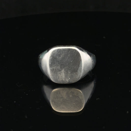 Silver signet ring in size V with a polished finish, featuring a classic design, unbranded jewelry accessory.