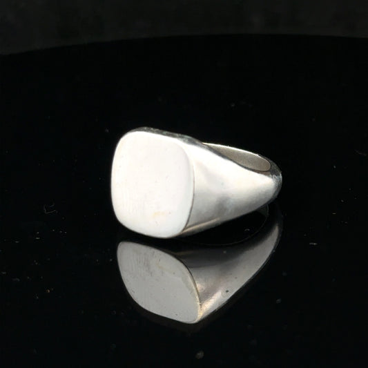 Silver signet ring in size V, unbranded, featuring a smooth, polished surface and classic design, shown in a close-up image.