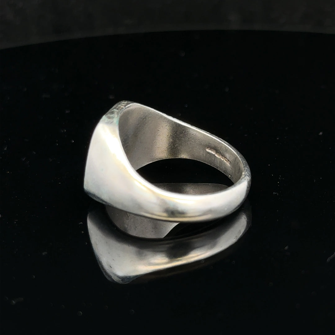 Silver signet ring in size V with a smooth, polished surface, unbranded jewelry piece featuring classic design.