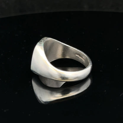Silver signet ring in size V with a smooth, polished surface, unbranded jewelry piece featuring classic design.