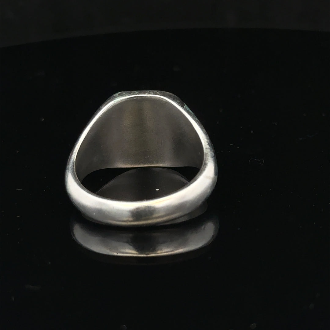 Silver signet ring in size V with a smooth, polished surface, unbranded, featuring a classic design suitable for everyday wear.