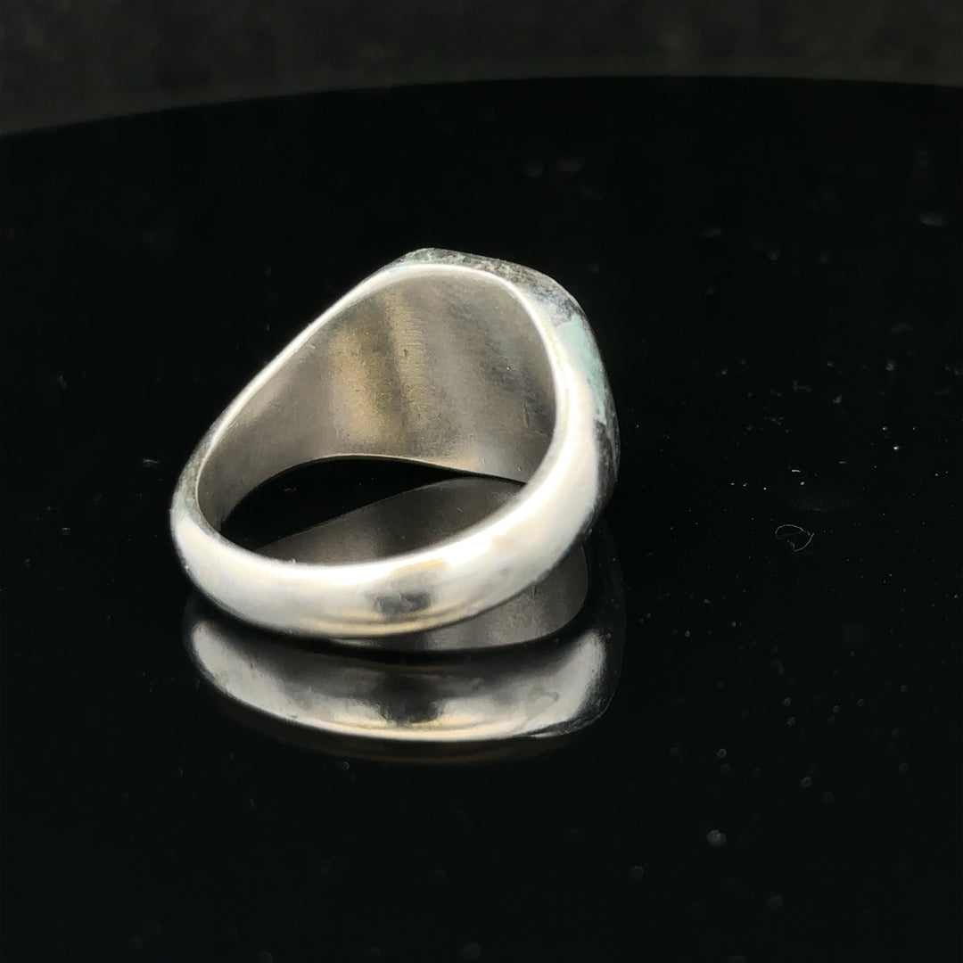 Silver signet ring in size V, unbranded, with smooth polished surface and classic design, displayed on a plain background.