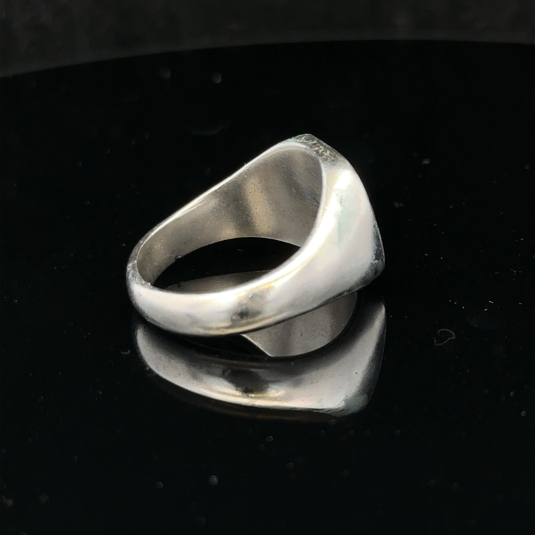 Silver signet ring in size V with a smooth band, unbranded jewelry, shown on a plain background.