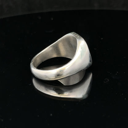 Silver signet ring in size V with a smooth band, unbranded jewelry, shown on a plain background.
