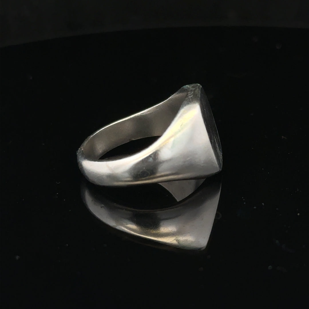 Silver signet ring in size V with a smooth, polished surface, unbranded jewelry, showcasing classic ring style.