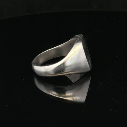 Silver signet ring in size V with a smooth, polished surface, unbranded jewelry, showcasing classic ring style.