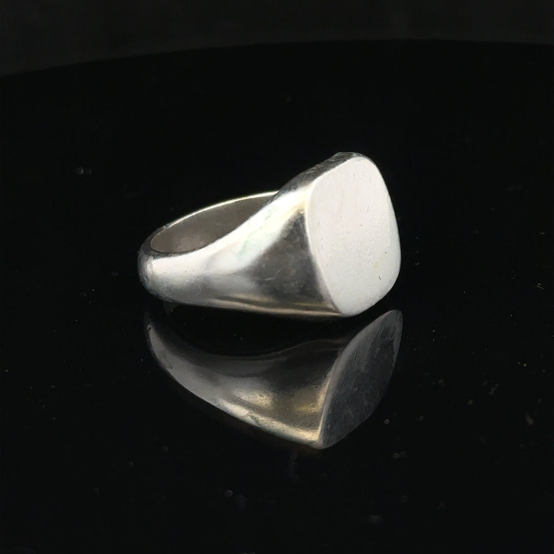 Silver signet ring in size V with a smooth finish, unbranded, featuring a classic design perfect for everyday wear.