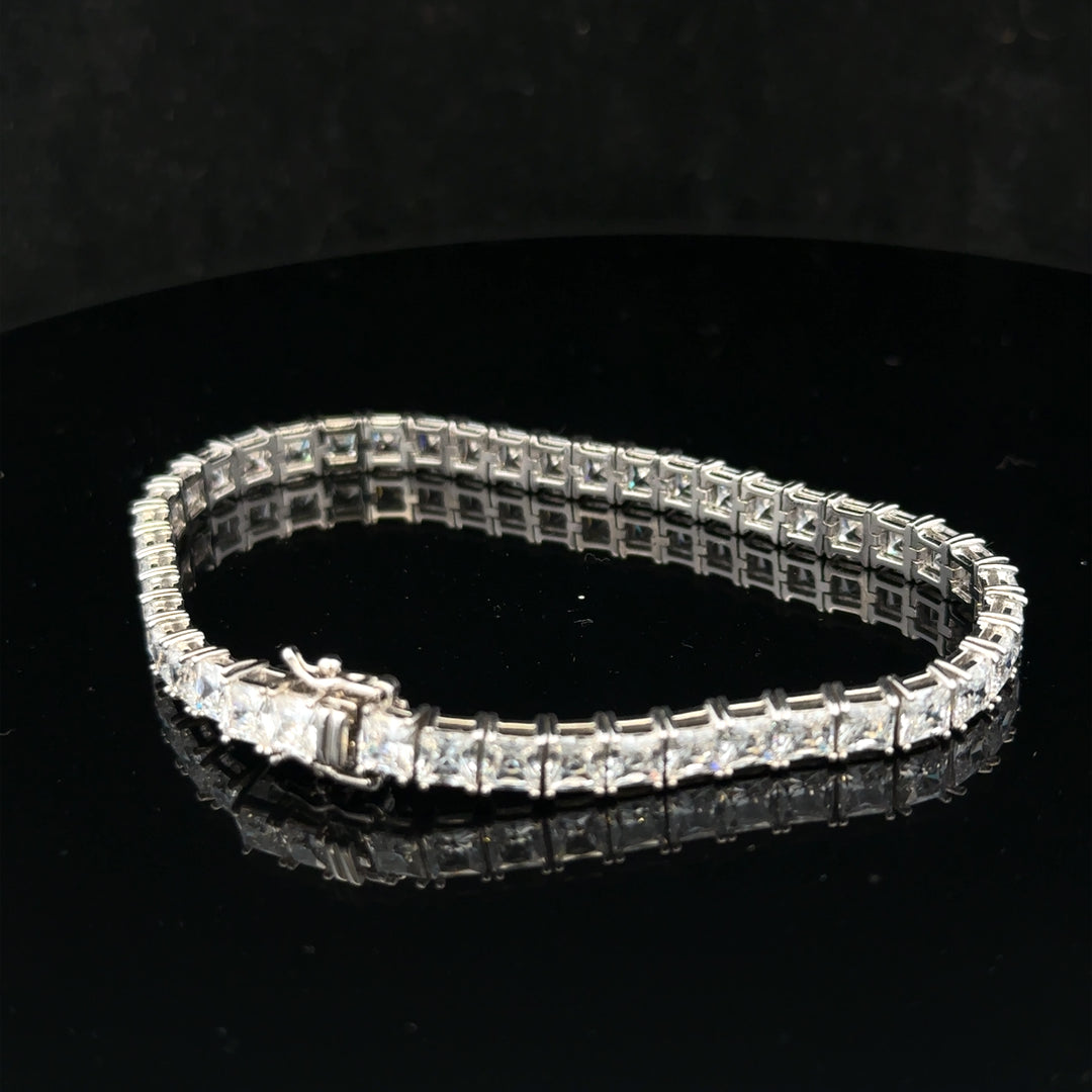 Silver tennis bracelet weighing 15.6g, featuring a sleek design with linked silver segments, unbranded style, close-up view
