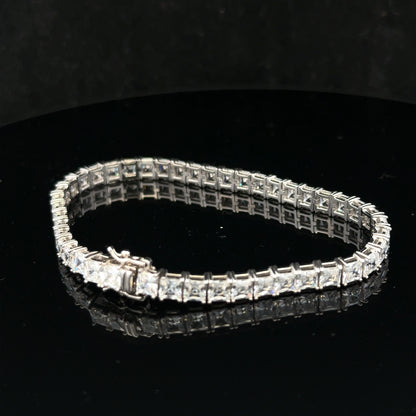 Silver tennis bracelet weighing 15.6g, featuring a sleek design with linked silver segments, unbranded style, close-up view