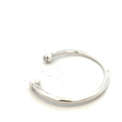 Silver torque bangle bracelet, unbranded 20g design with a sleek, polished finish on a plain background.