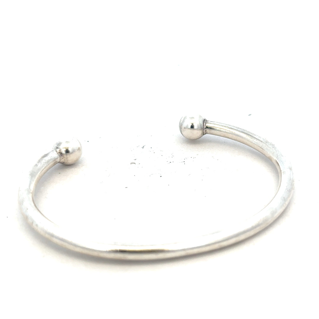 Silver torque bracelet, unbranded 20g bangle with a sleek, minimalist design, showcasing a smooth metallic finish.