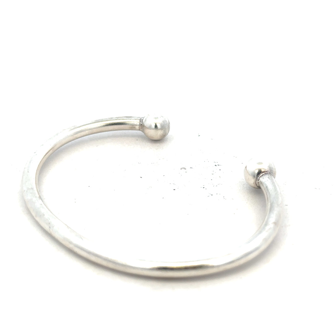 Silver torque bangle bracelet with 20g weight, unbranded, featuring a sleek, minimalist design in polished silver.