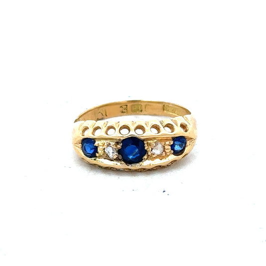 Vintage 18ct yellow gold sapphire and diamond ring with intricate detailing and a classic design.